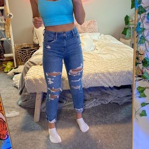 AE high rise jean. rips on front and back.